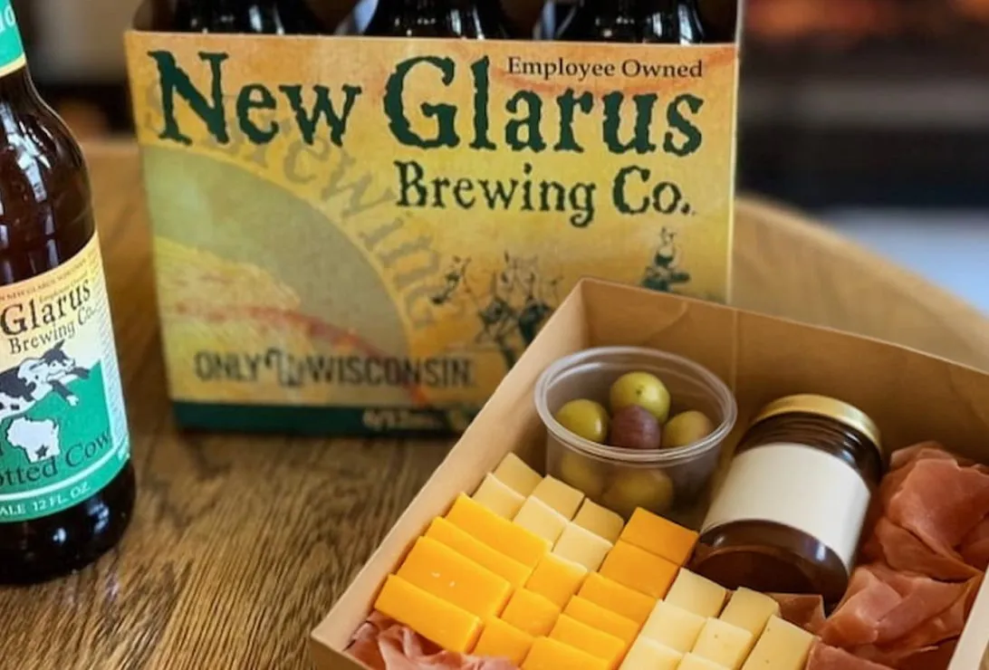six pack of beer with small charcuterie box