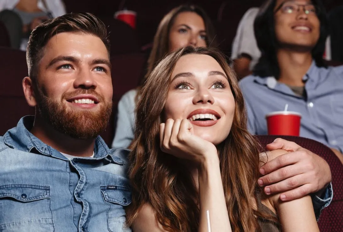 young couple sitting in the movie theater